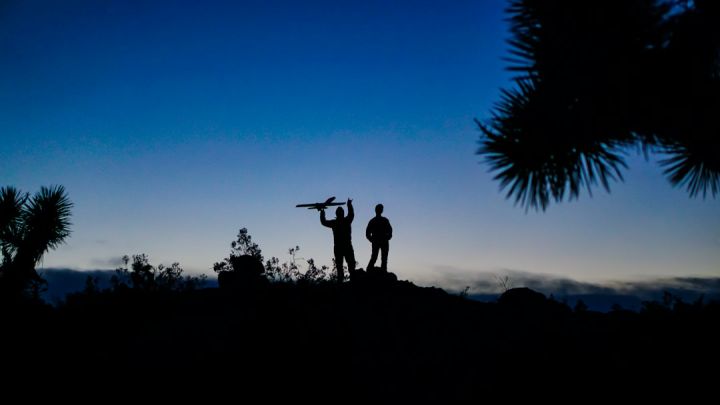 Remote Control Planes - silhouette photo of man standing on boulder