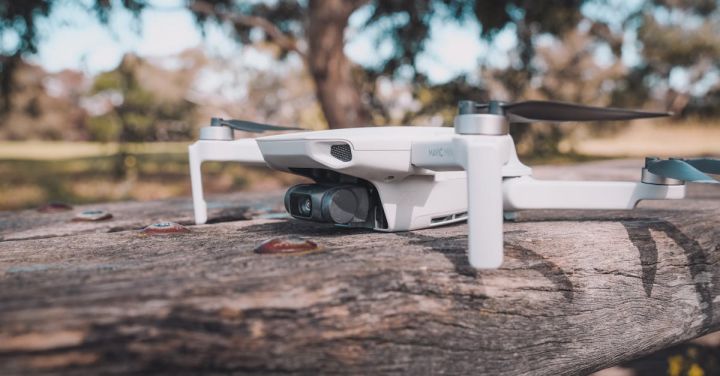 Remote Control Planes - White and Black Drone on Wooden Table