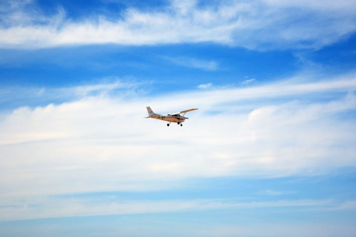 Flight Training - white and black airplane flying under blue sky during daytime