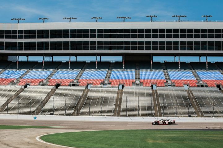 Fpv Racing - aerial photography of car on stadium under clear blue sky