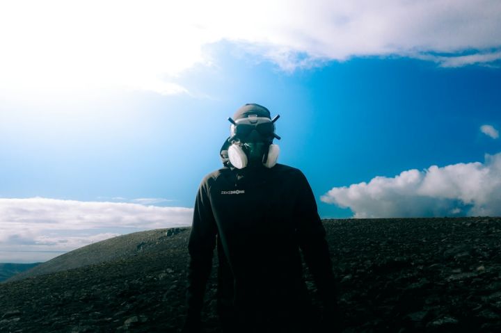 Fpv - a man wearing a helmet and goggles on top of a mountain