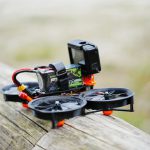 Fpv - a camera sitting on top of a piece of wood