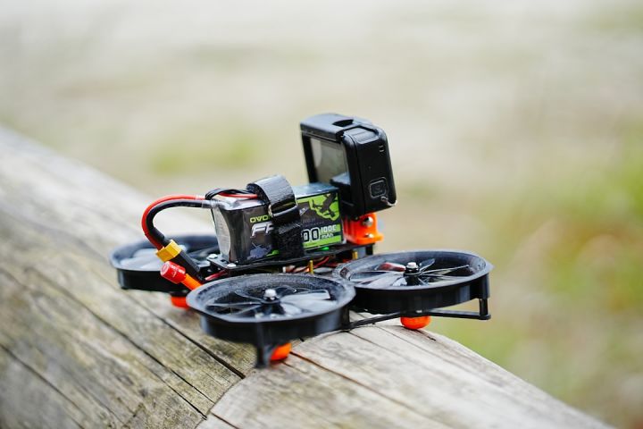 Fpv - a camera sitting on top of a piece of wood