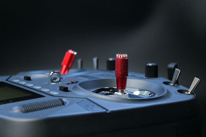 Fpv - a close up of a device with a red handle