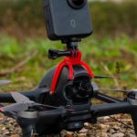 Fpv - DJI FPV Drone with Mounted Panoramic Action Camera QooCam 3 on the Ground