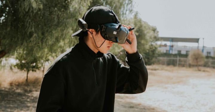 Fpv - A man in black sweatshirt and hat holding a phone